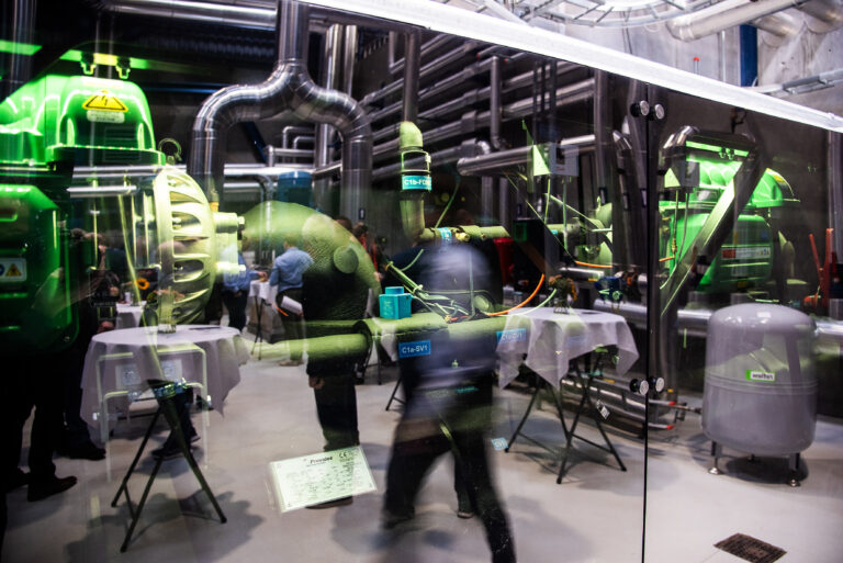 ME Production industrial installation with machinery, piping systems and visitors